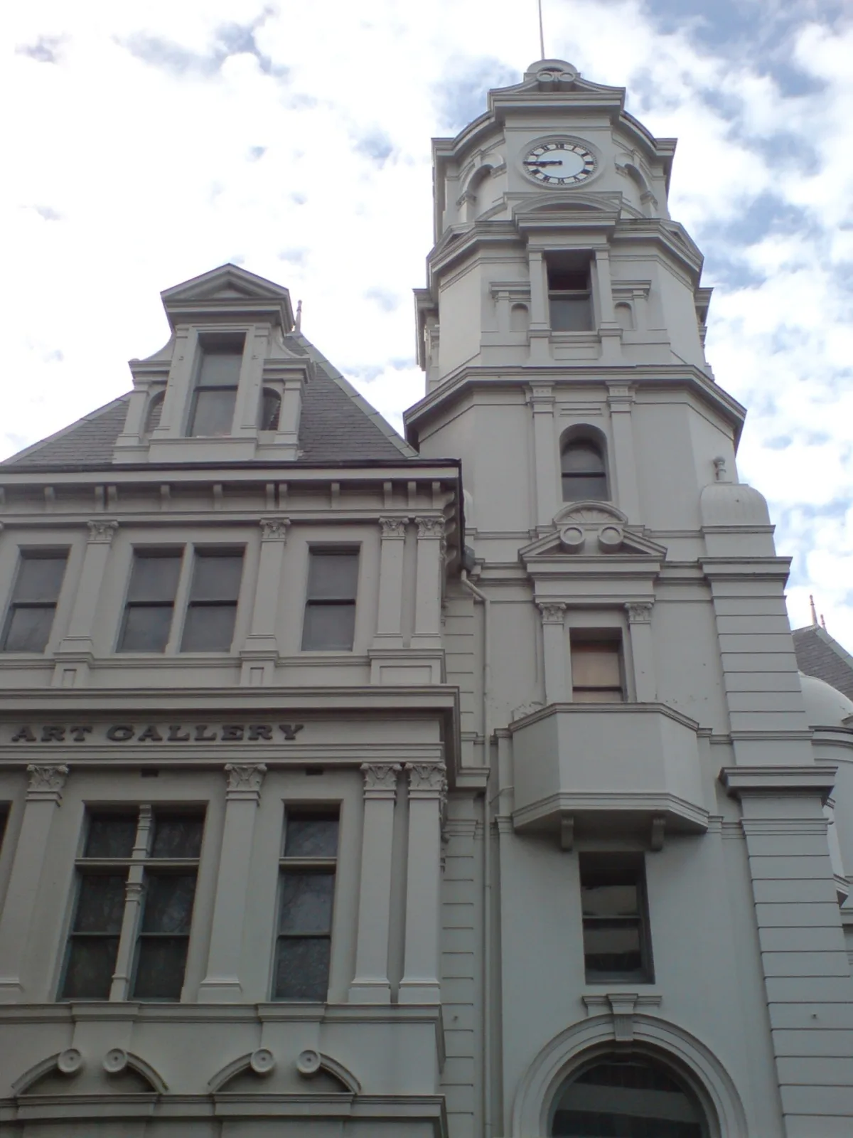 The grey heritage facade of the Auckland Art Gallery with its “Art Gallery” lettering and ornate windows