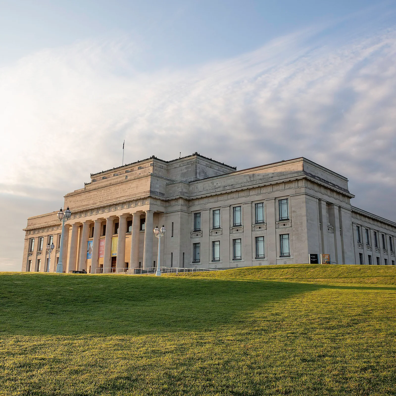 The columned, neoclassical facade of the Auckland War Memorial Museum on a grassy hill