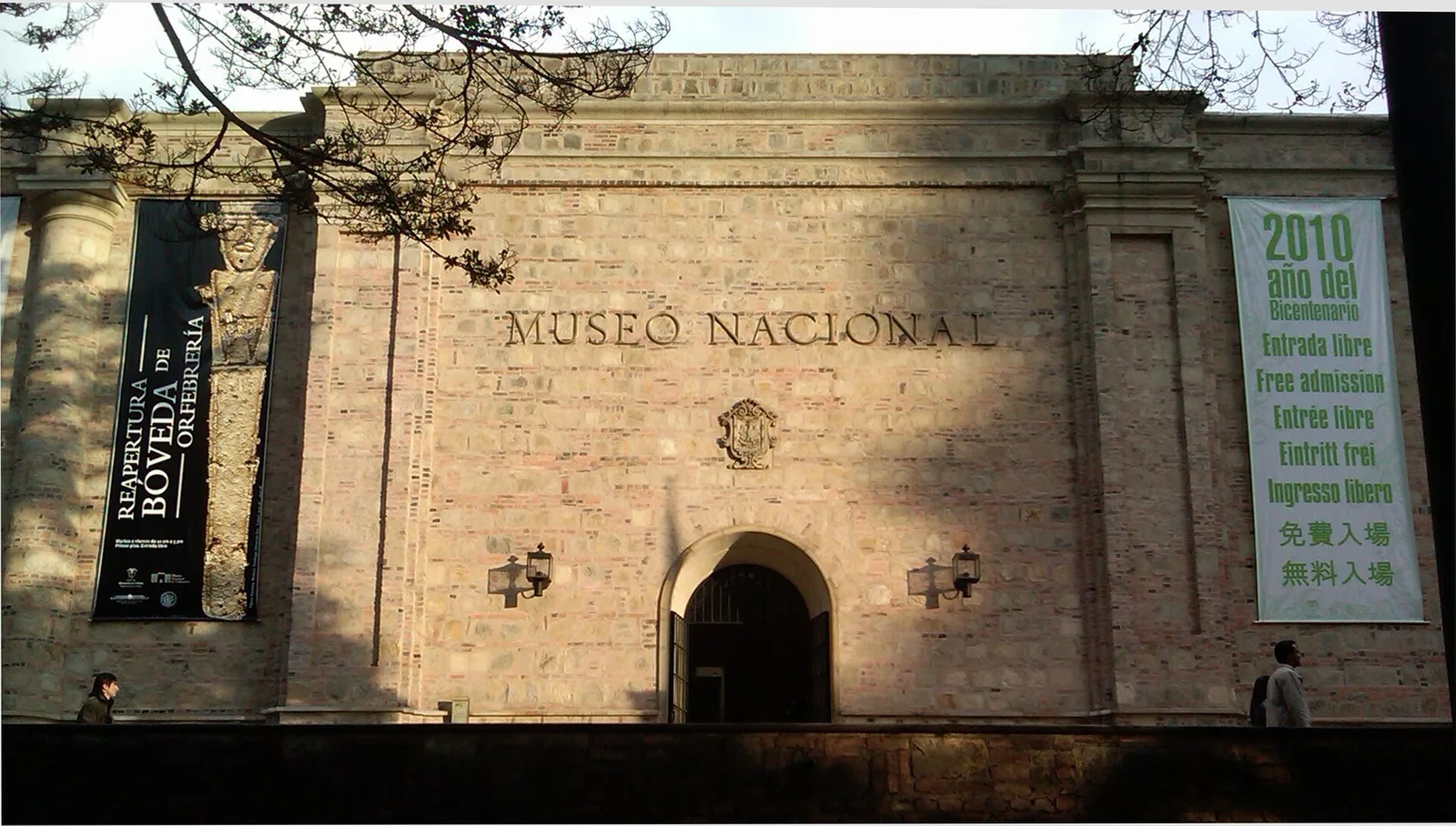 The stone facade of the Museo Nacional de Colombia with the museum name above its arched entrance