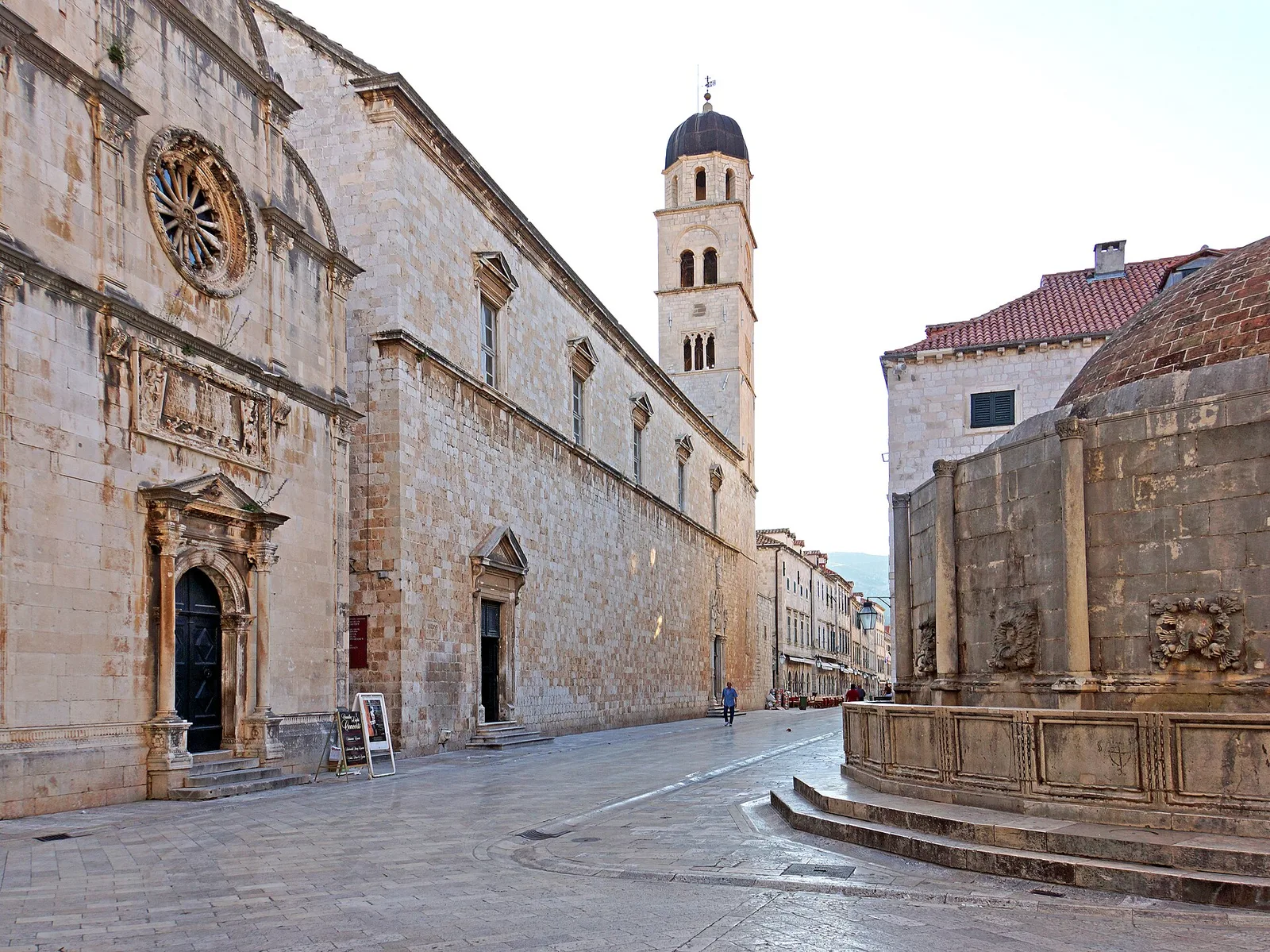 The Franciscan bell tower rising beside the Large Onofrio Fountain at the Pile end of the Stradun