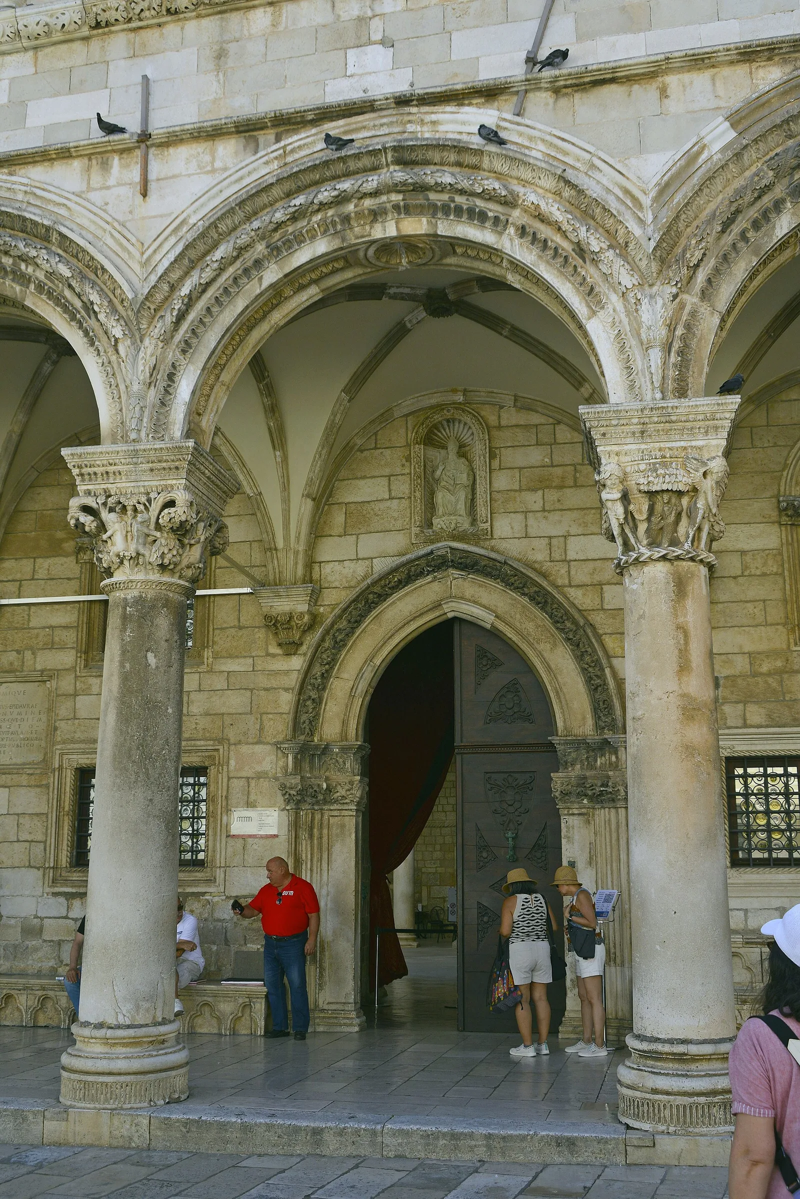 The arcaded entrance of the Rector's Palace, with carved capitals and a Gothic doorway