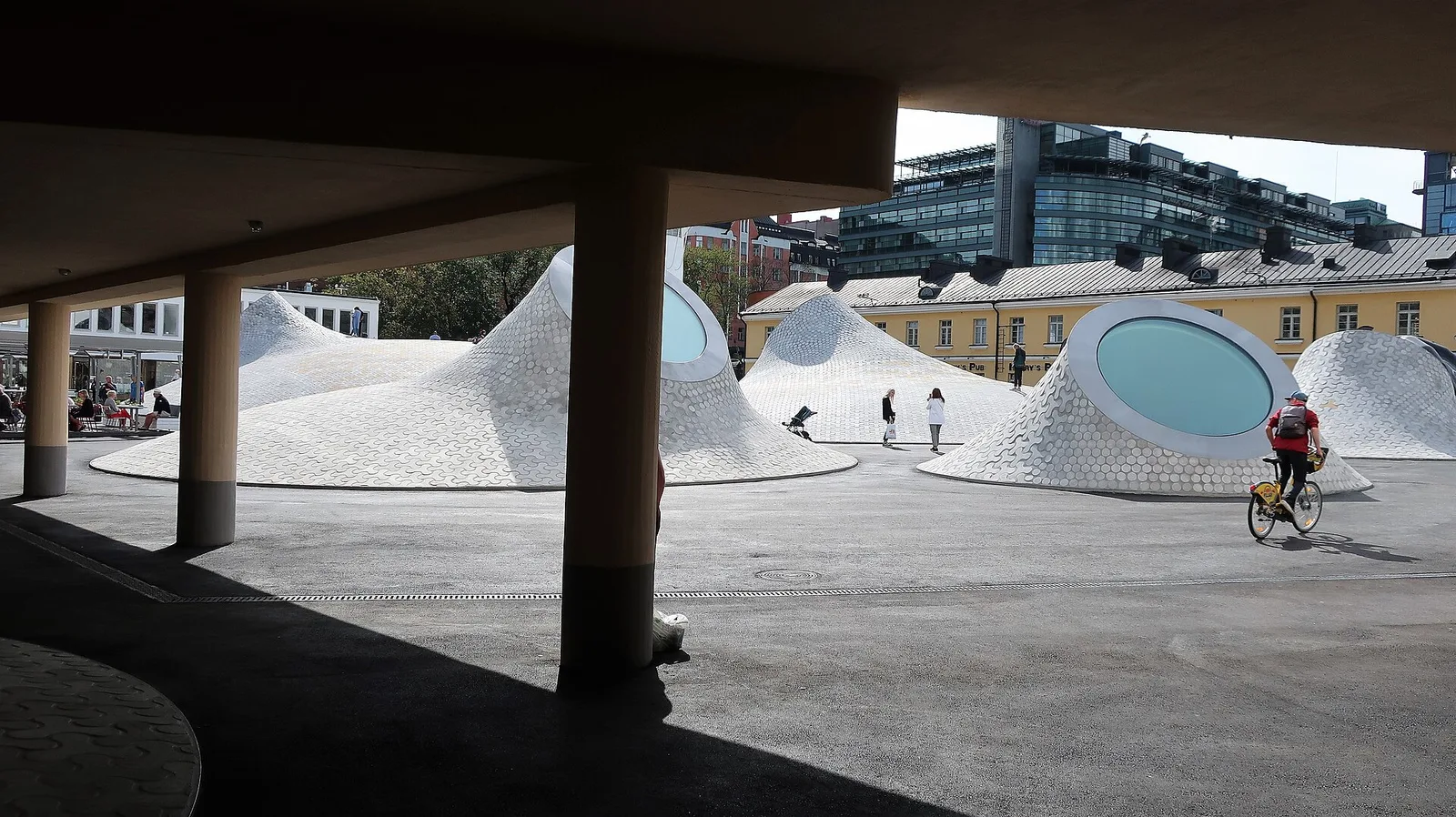 Rounded, tiled skylight domes with oval windows on the plaza above the Amos Rex museum