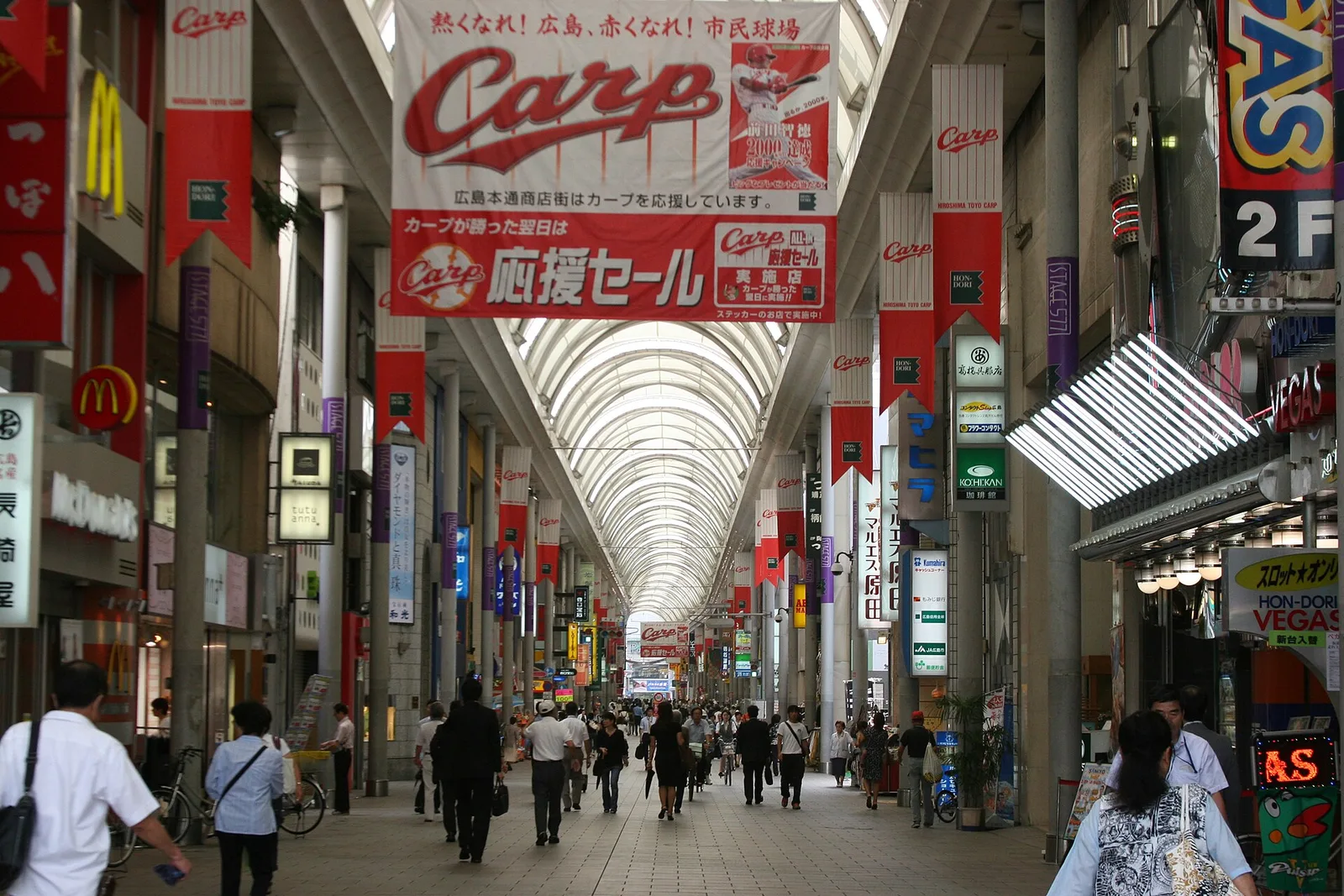The covered Hondori shopping arcade with a baseball banner and a crowd of shoppers