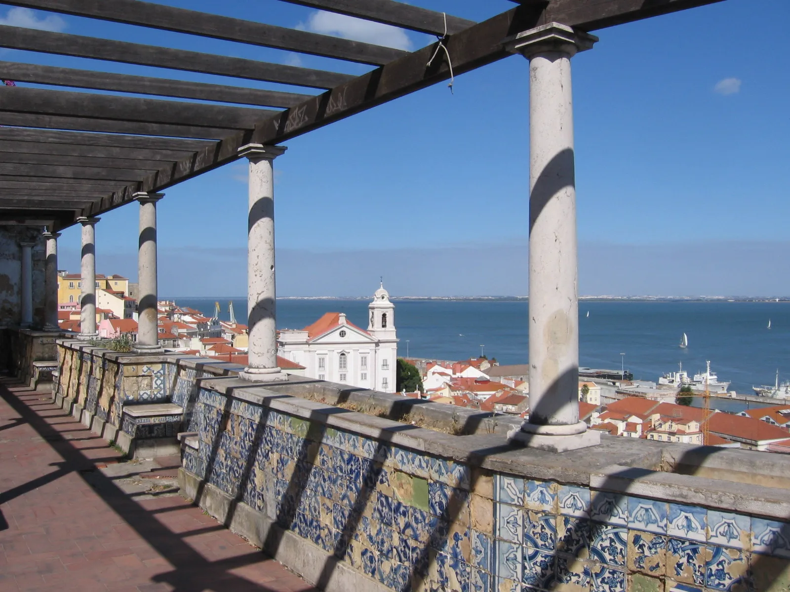 Tiled terrace at Miradouro de Santa Luzia overlooking Alfama and the Tagus