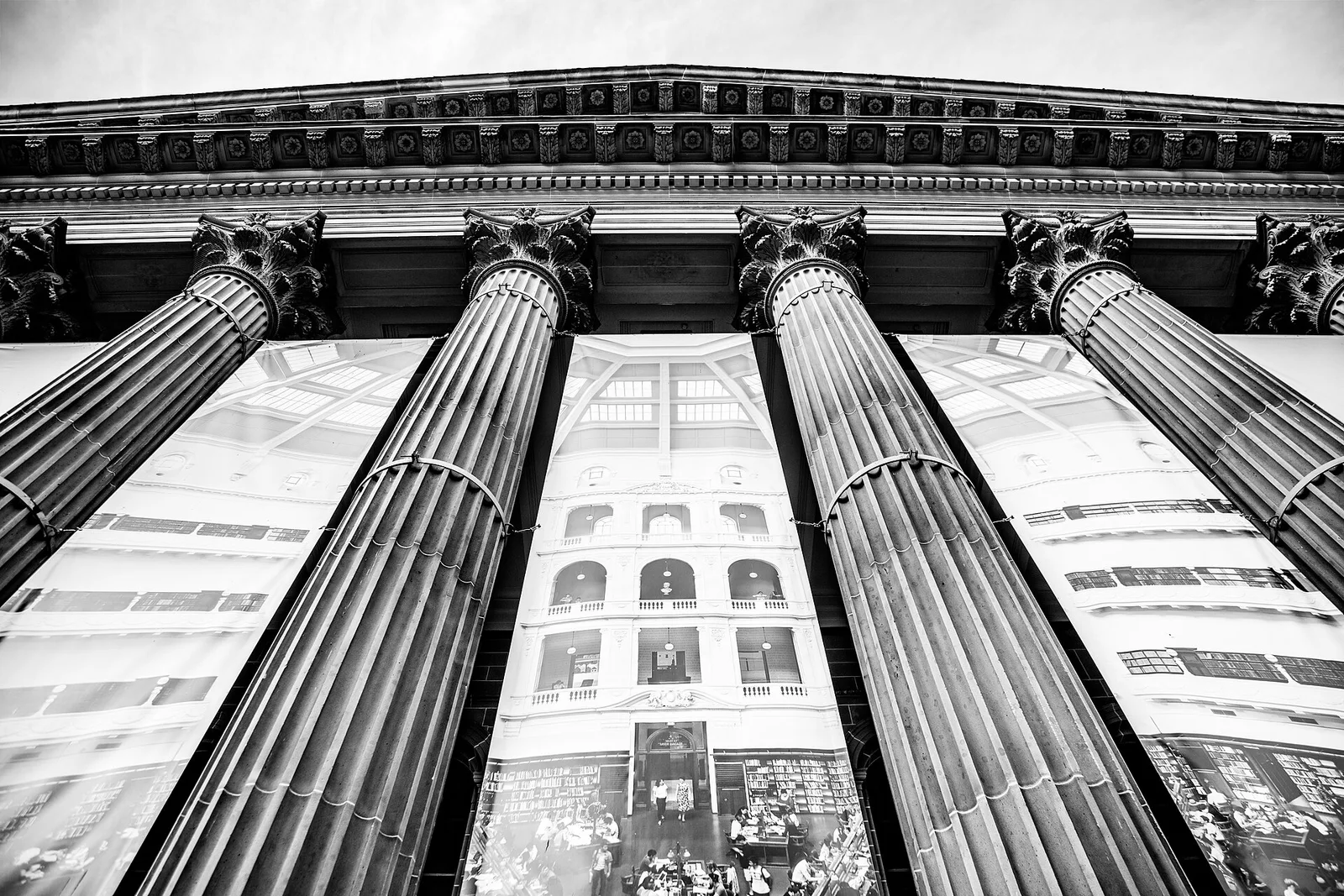 Fluted columns on the front of State Library Victoria, hung with banners showing the La Trobe Reading Room