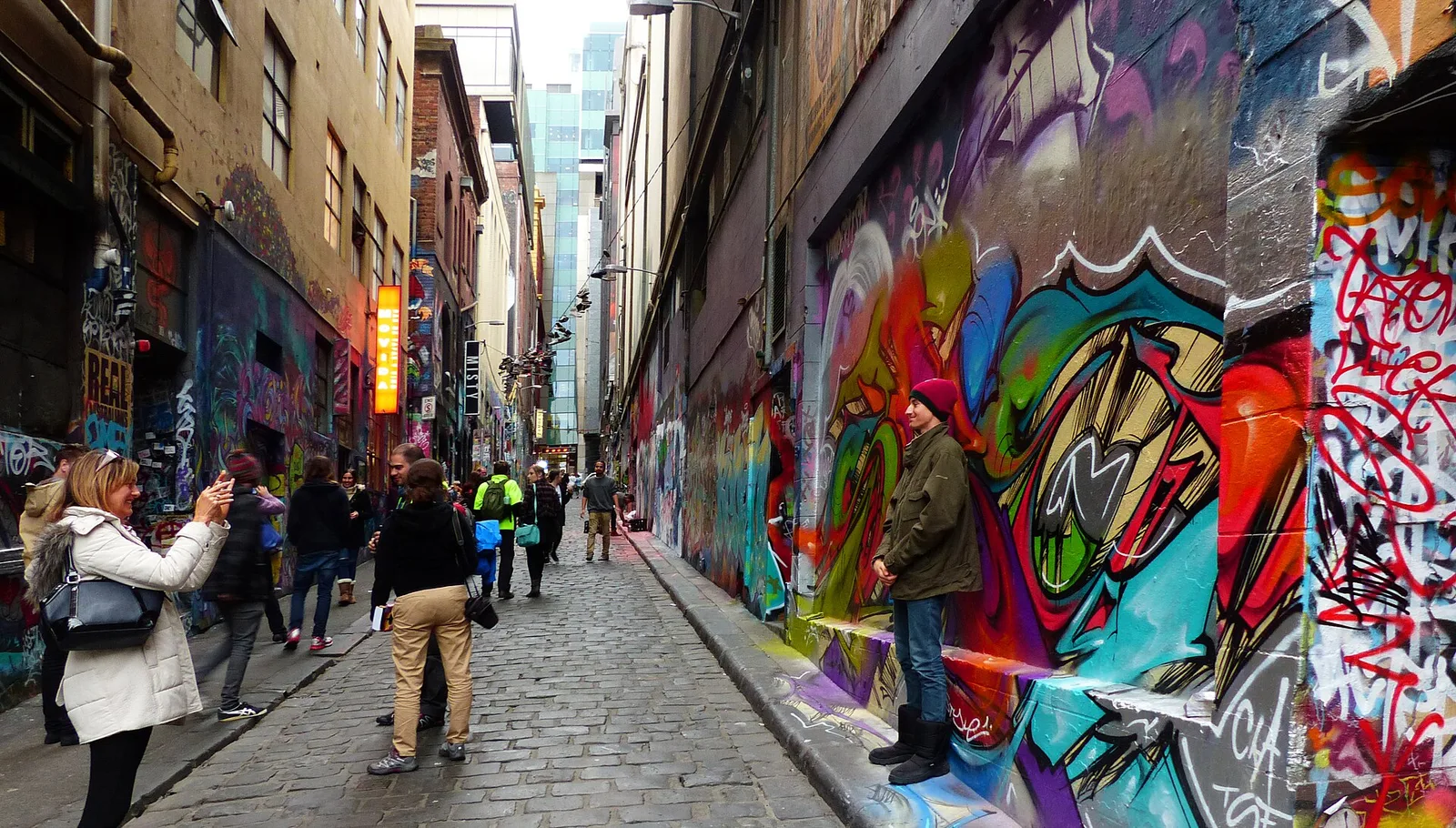 Colourful stencil and spray-paint art covering the bluestone walls of Hosier Lane
