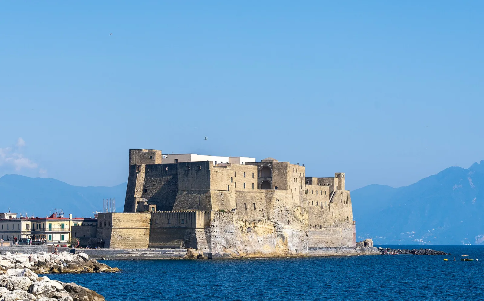 Castel dell'Ovo on its rocky islet beside the blue Bay of Naples