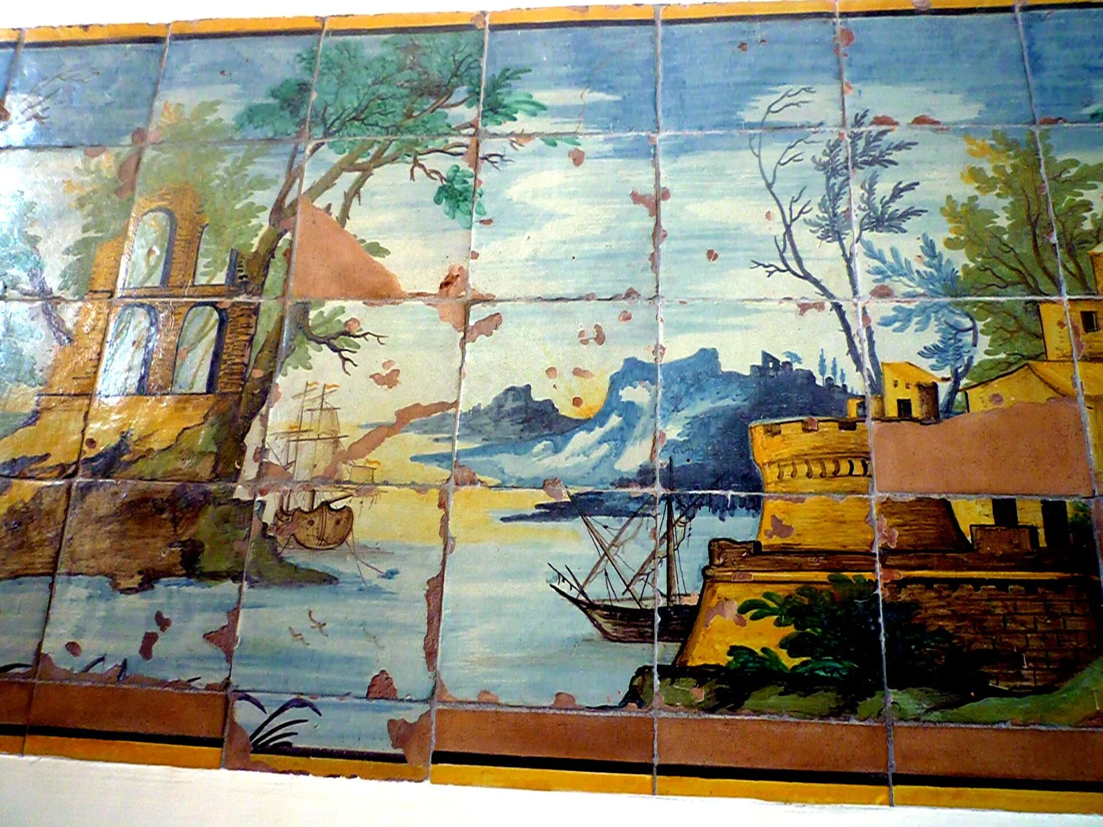 A panel of painted majolica tiles showing a harbor scene, from the Santa Chiara cloister