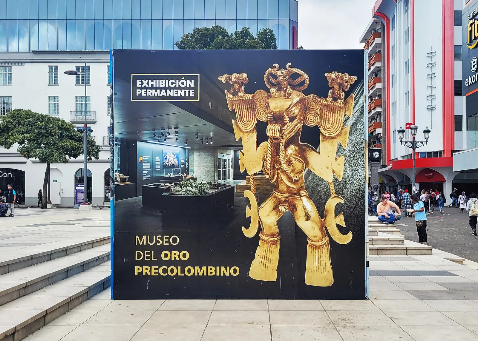 A large banner at the Pre-Columbian Gold Museum showing a gold figure beside the words Museo del Oro Precolombino