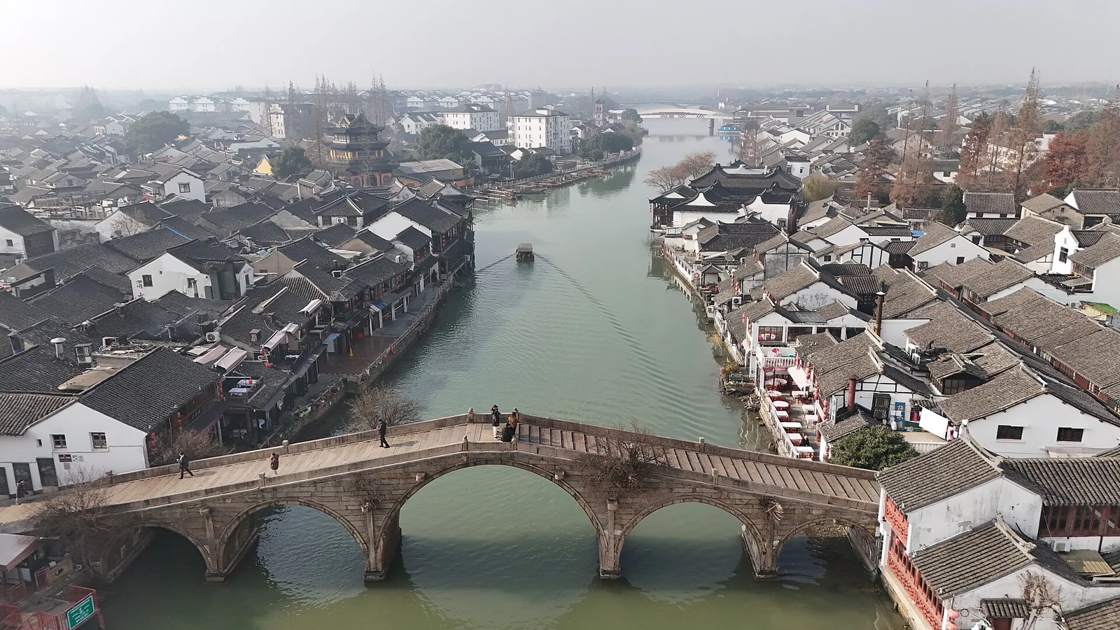 An aerial view of the Zhujiajiao canal lined with old tiled-roof houses