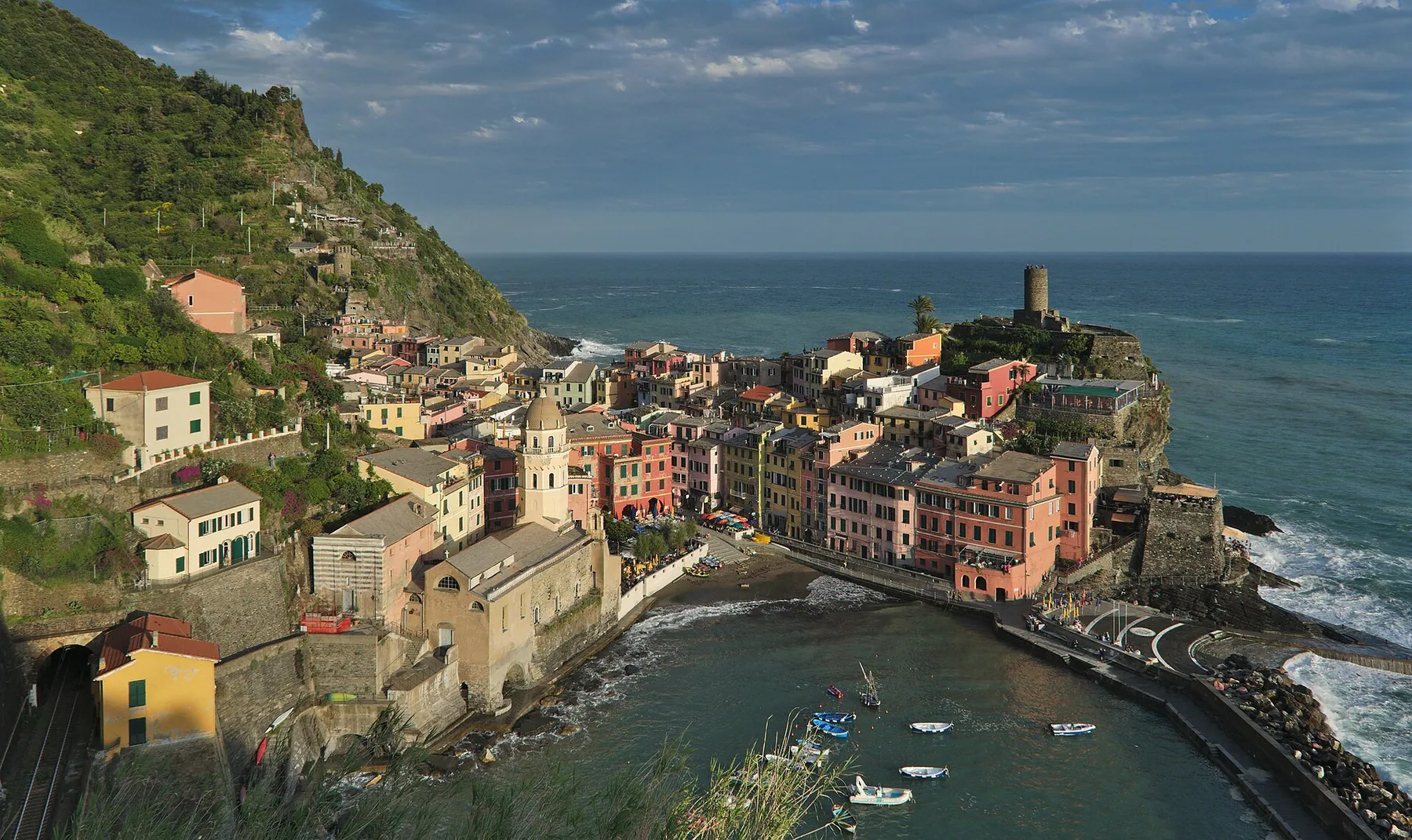 Vernazza’s pastel houses and small harbor on the Ligurian coast, seen from the Azure Trail