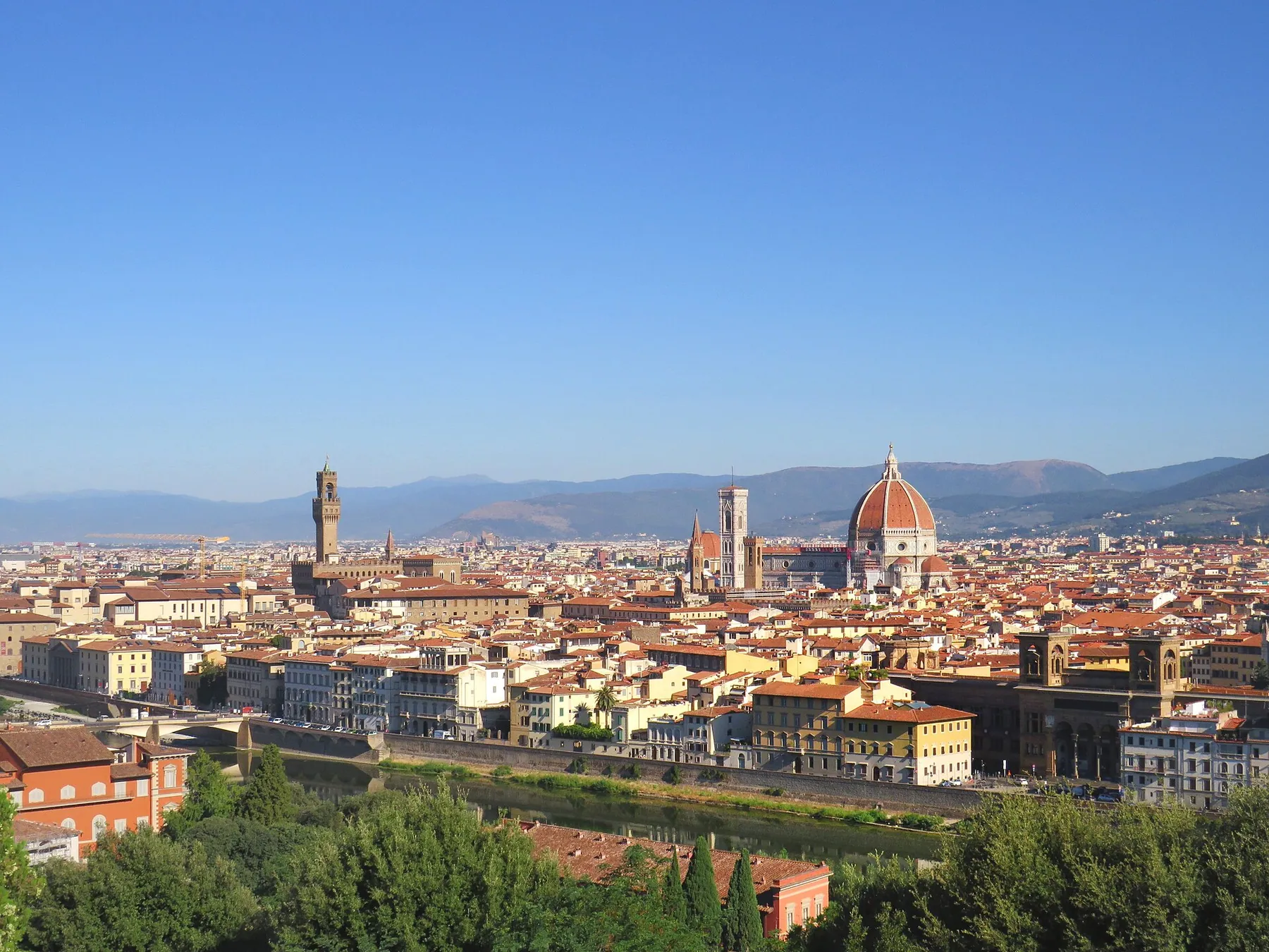 Florence seen from Piazzale Michelangelo, with the red dome of the Duomo and the Palazzo Vecchio tower above the rooftops